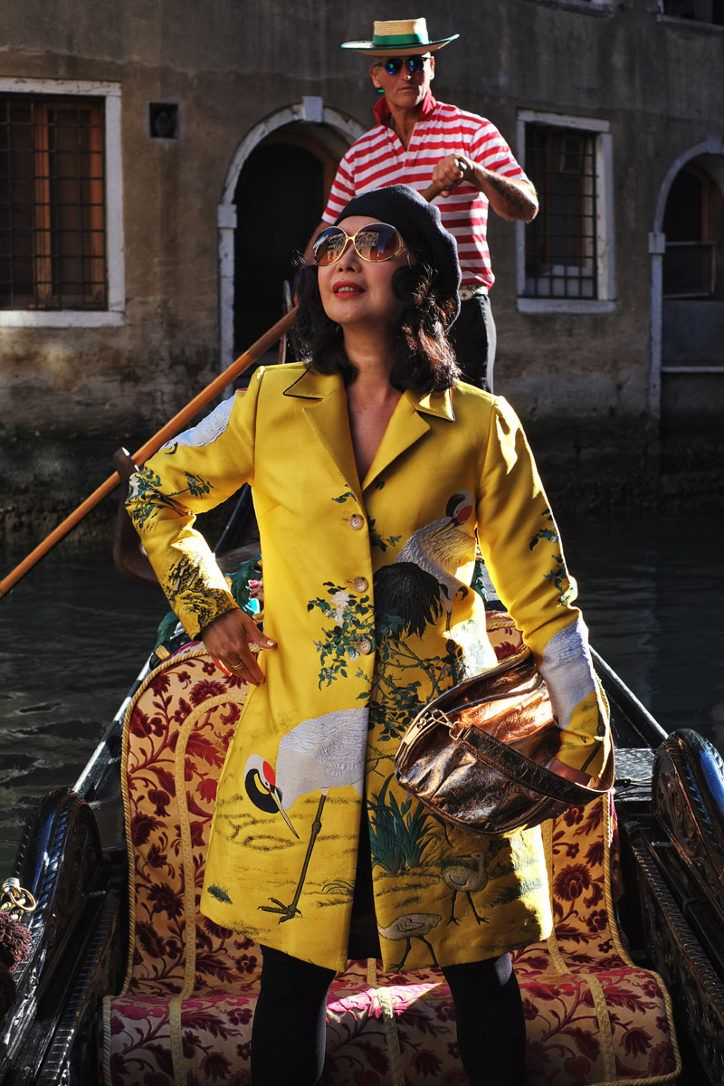 Fashion photoshoot on a Venetian gondola with a Venetian gondolier by photographer Kent Johnson. Styling and modelling by Vivienne She for White Caviar Life.