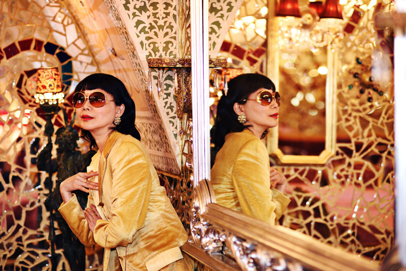 Vivienne She, writer/creator of White Caviar Life in a golden yellow suit. 'Mirror Mirror on the Wall' fashion story by White Caviar Life. Portraits in a mirror room. Fashion photography on location in Prague by Sydney photographer Kent Johnson.
