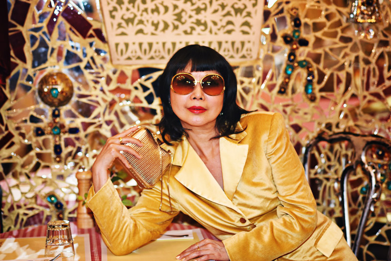 Vivienne She, writer/creator of White Caviar Life in a golden yellow suit. 'Mirror Mirror on the Wall' fashion story by White Caviar Life. Portraits in a mirror room. Fashion photography on location in Prague by Sydney photographer Kent Johnson.